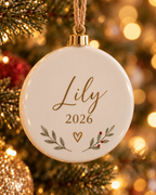 Close-up of the printed name, year and leaf design on the ceramic ornament
