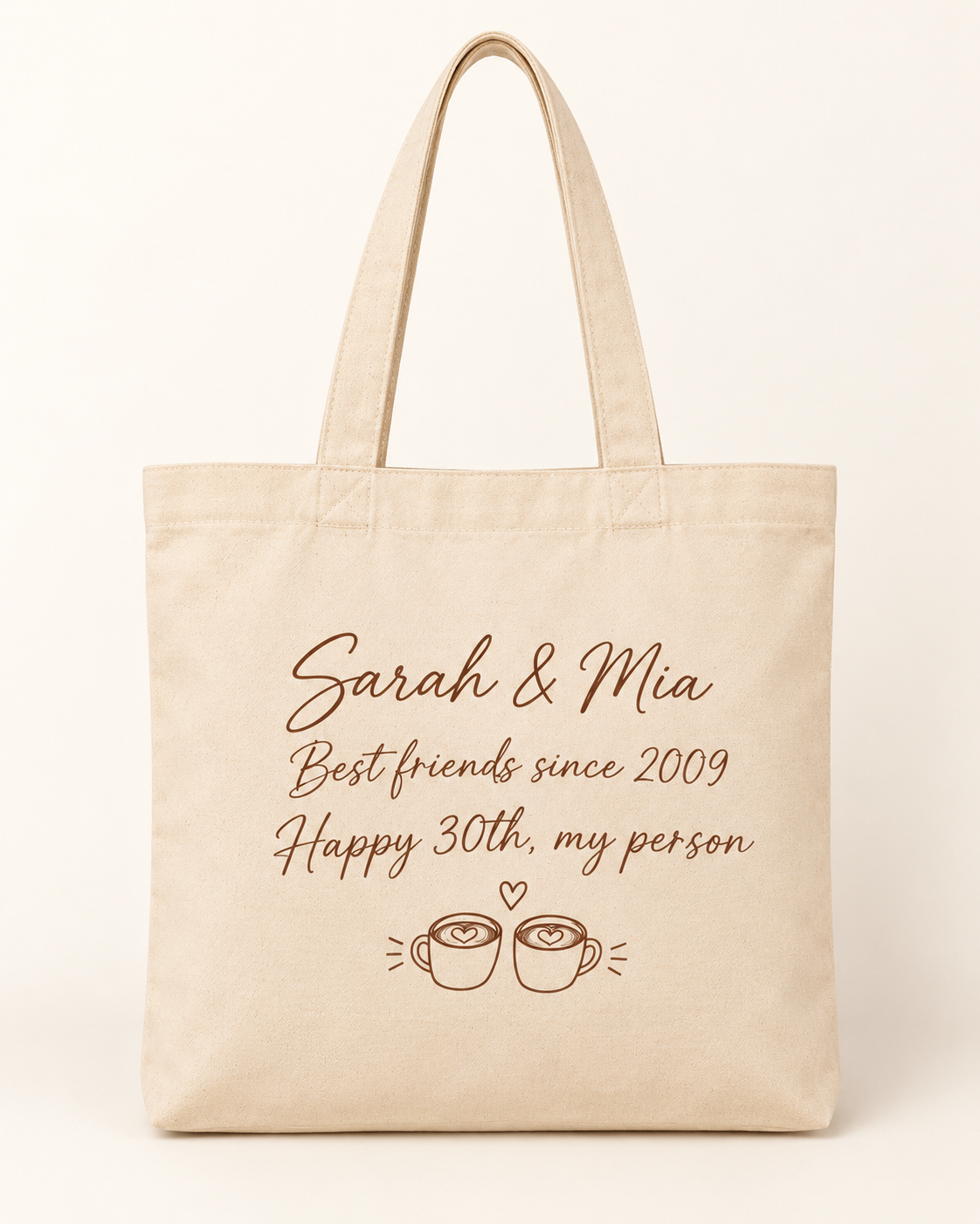 Our Story personalized canvas tote bag with custom names, message and coffee cup design on a plain cream background