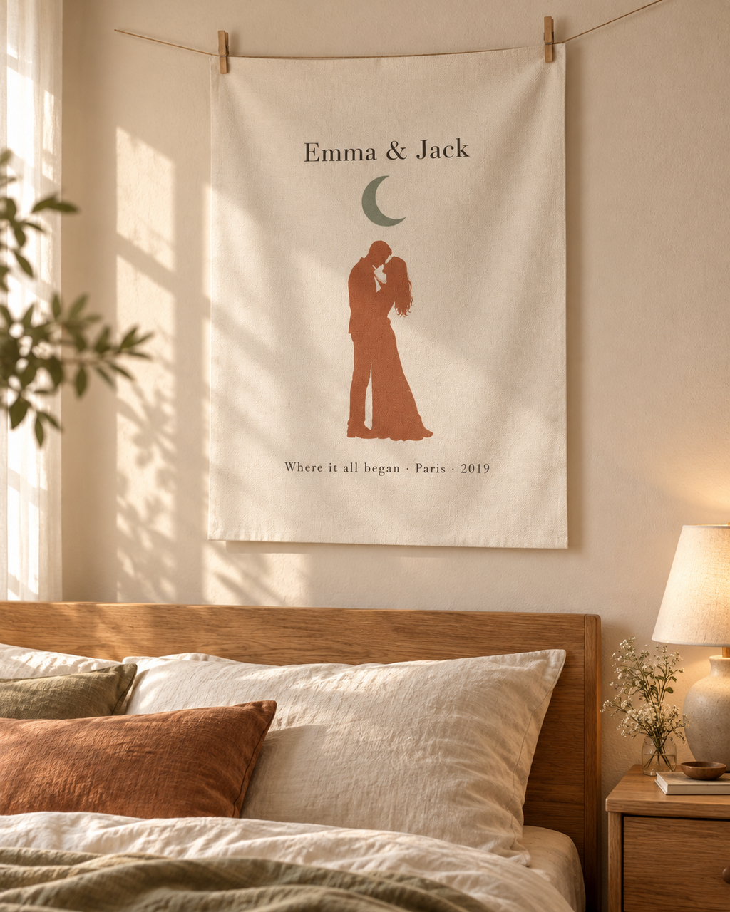 Unframed personalized couple canvas print hung with clips above a bed in a cozy bedroom