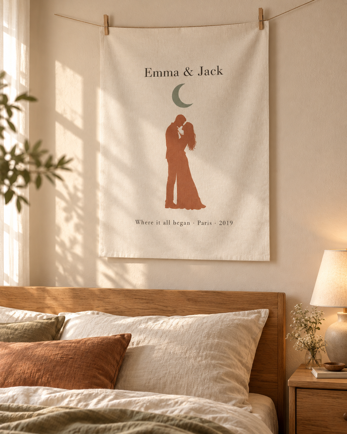 Unframed personalized couple canvas print hung with clips above a bed in a cozy bedroom