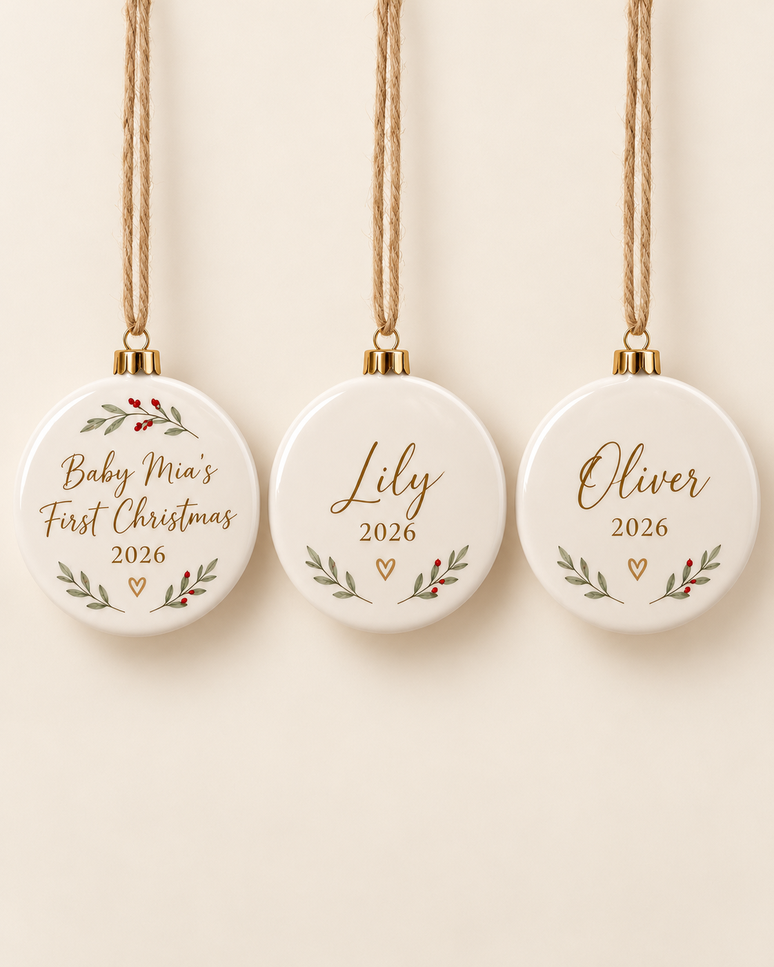 Set of three personalized ceramic Christmas ornaments on a plain cream background