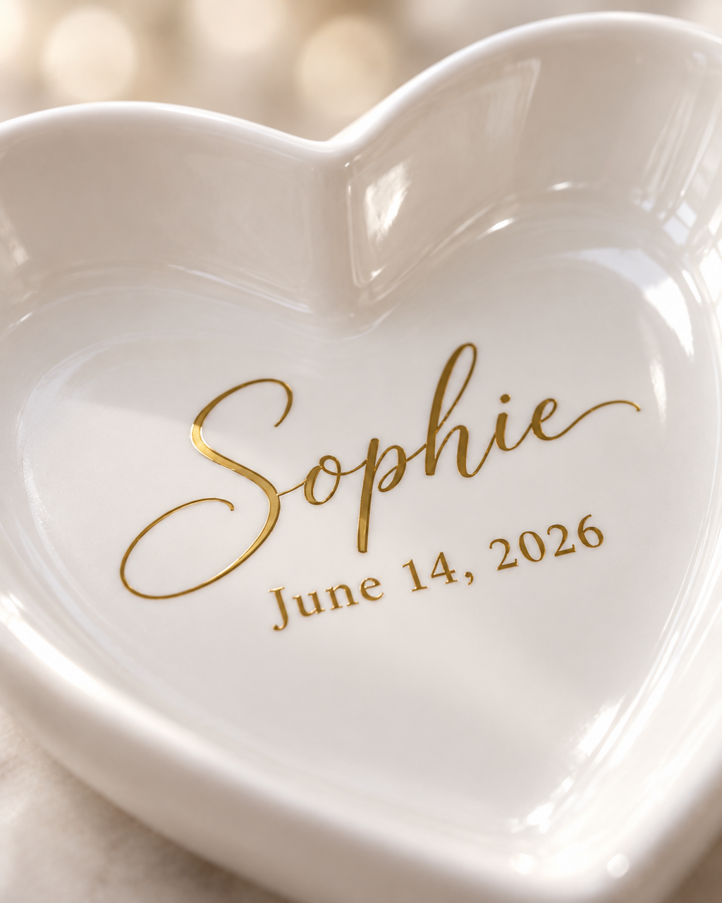 Close-up of the gold script name and date on the heart trinket tray