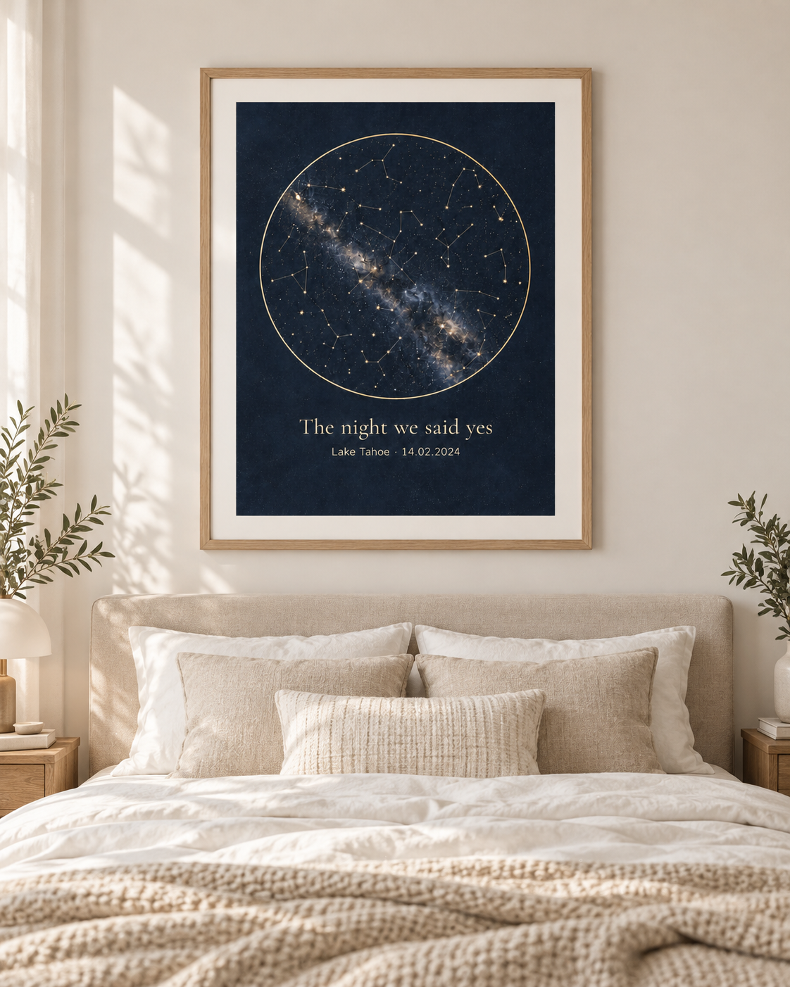 Where We Met custom star map poster in an oak frame above a bed (shown framed for styling; frame not included — poster ships unframed, rolled in a protective tube)